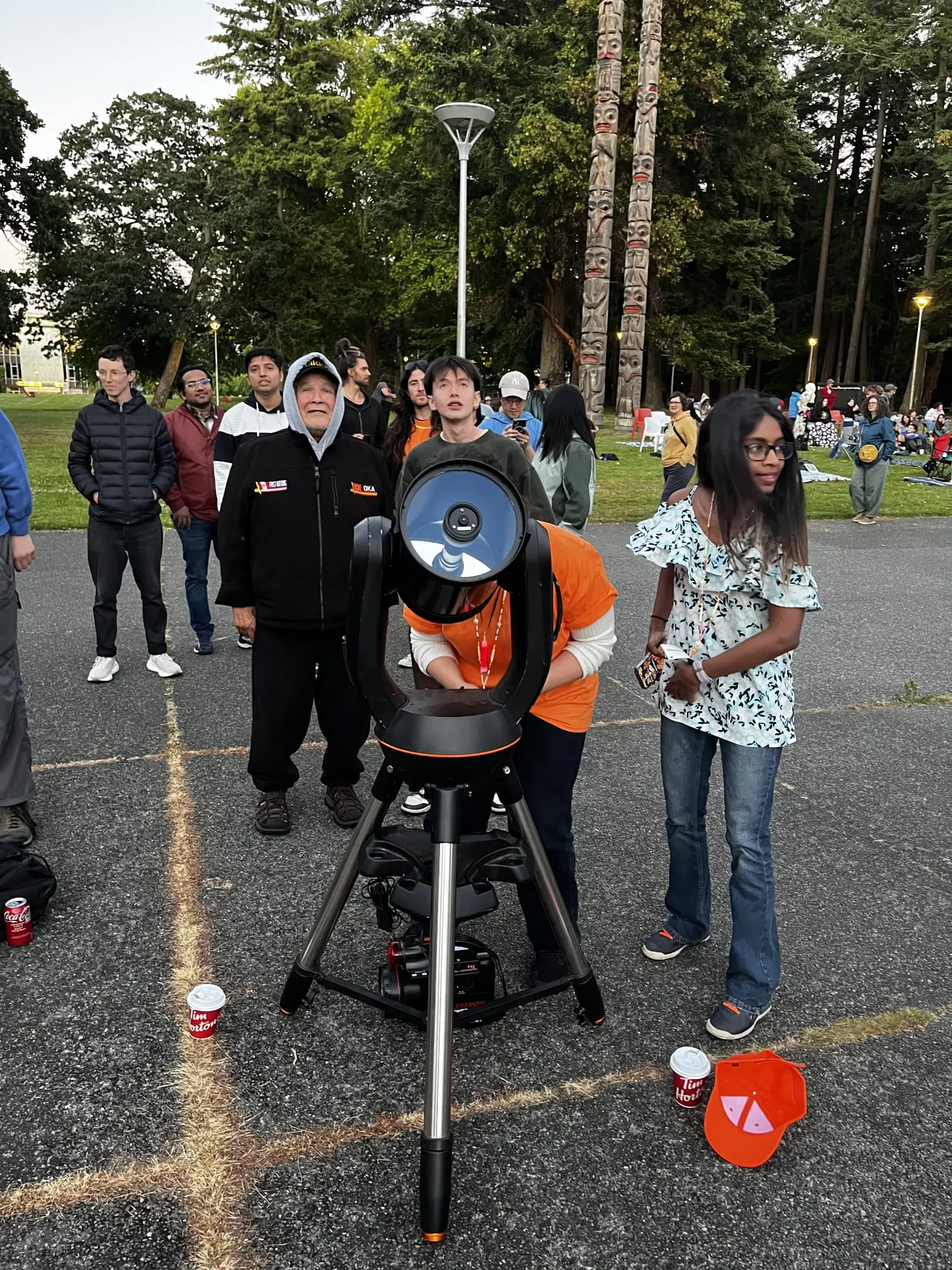 Participants gathered around a telescope at the Indigenous Star Gathering